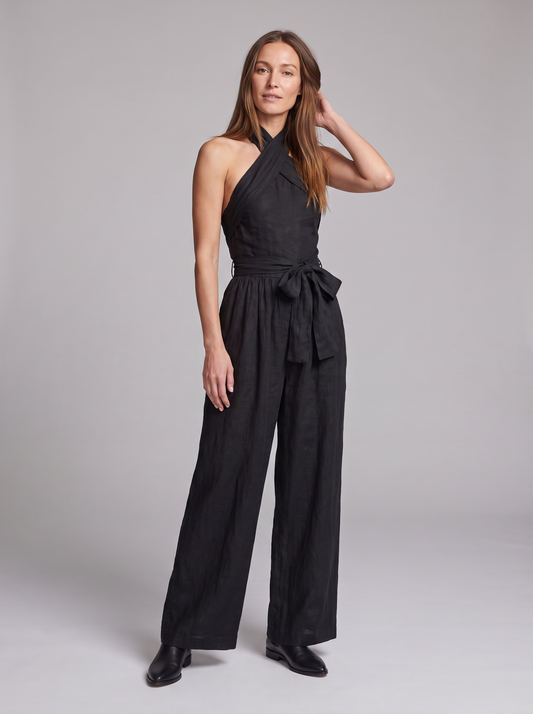 Cross Halter Wide-Leg Jumpsuit in Black – full-length front view, hand in hair