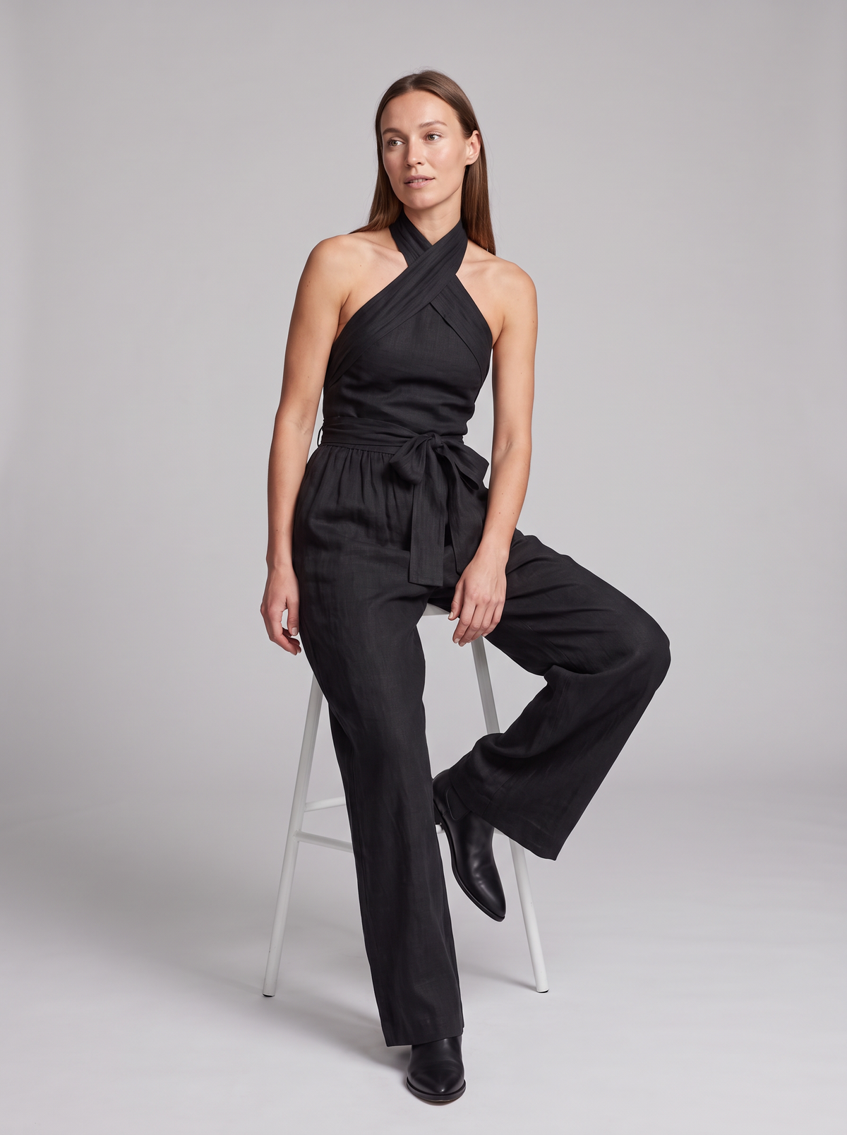 Cross Halter Wide-Leg Jumpsuit in Black – seated view