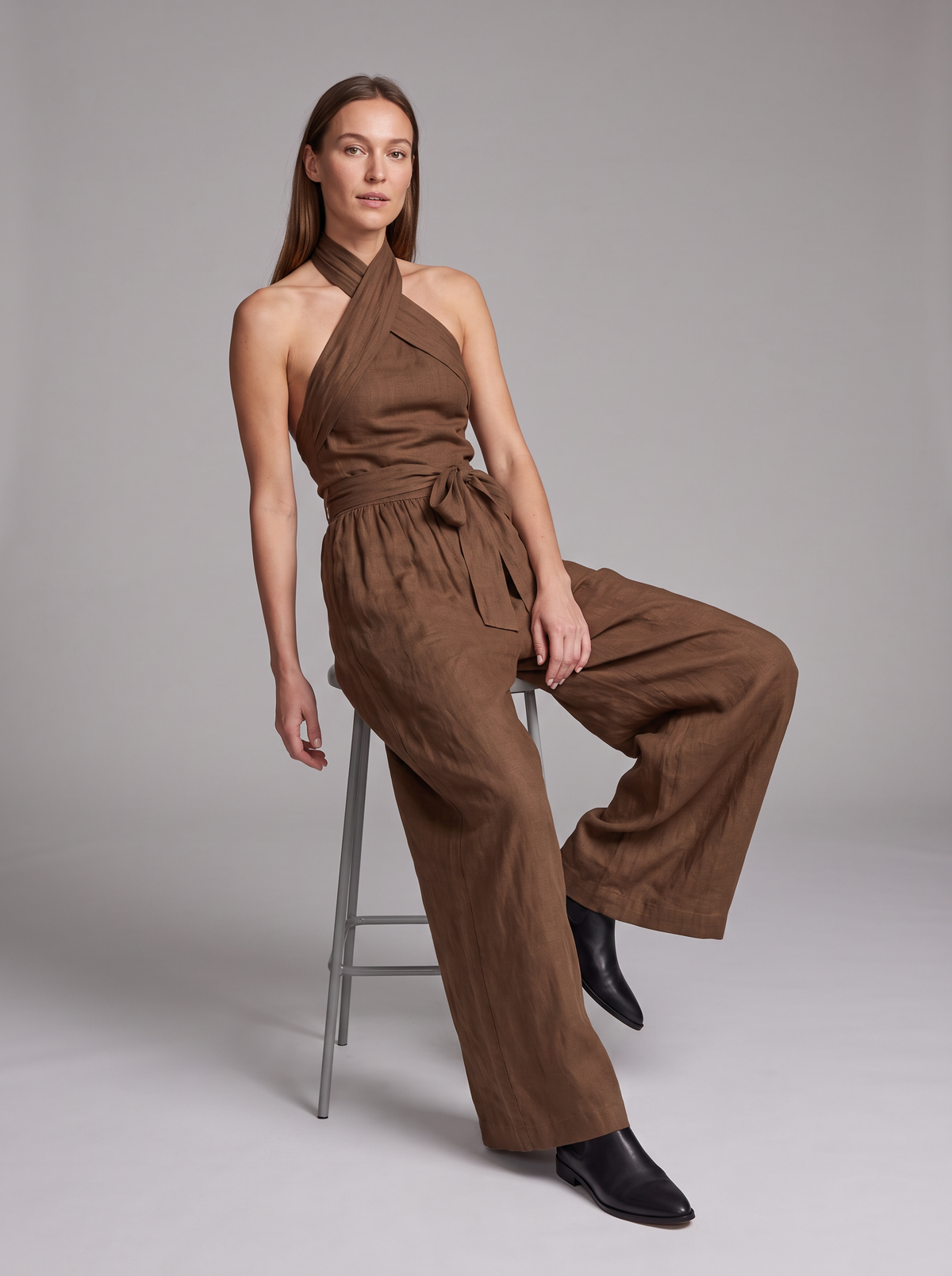 Cross Halter Wide-Leg Jumpsuit in Brown – seated view