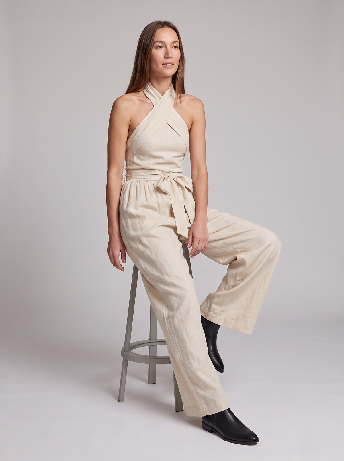 Cross Halter Wide-Leg Jumpsuit in White – seated view