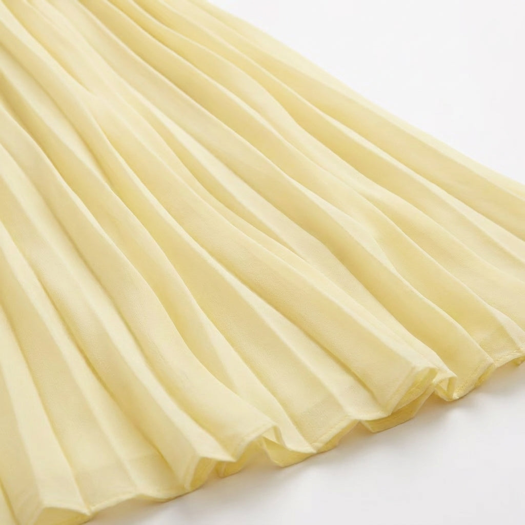 Pleated Halter Cut-Out Maxi Dress in Light Canary – close-up of the pleated skirt