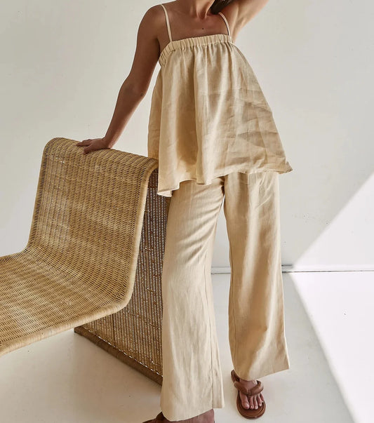 Beige cami top and wide leg pants with rattan chair