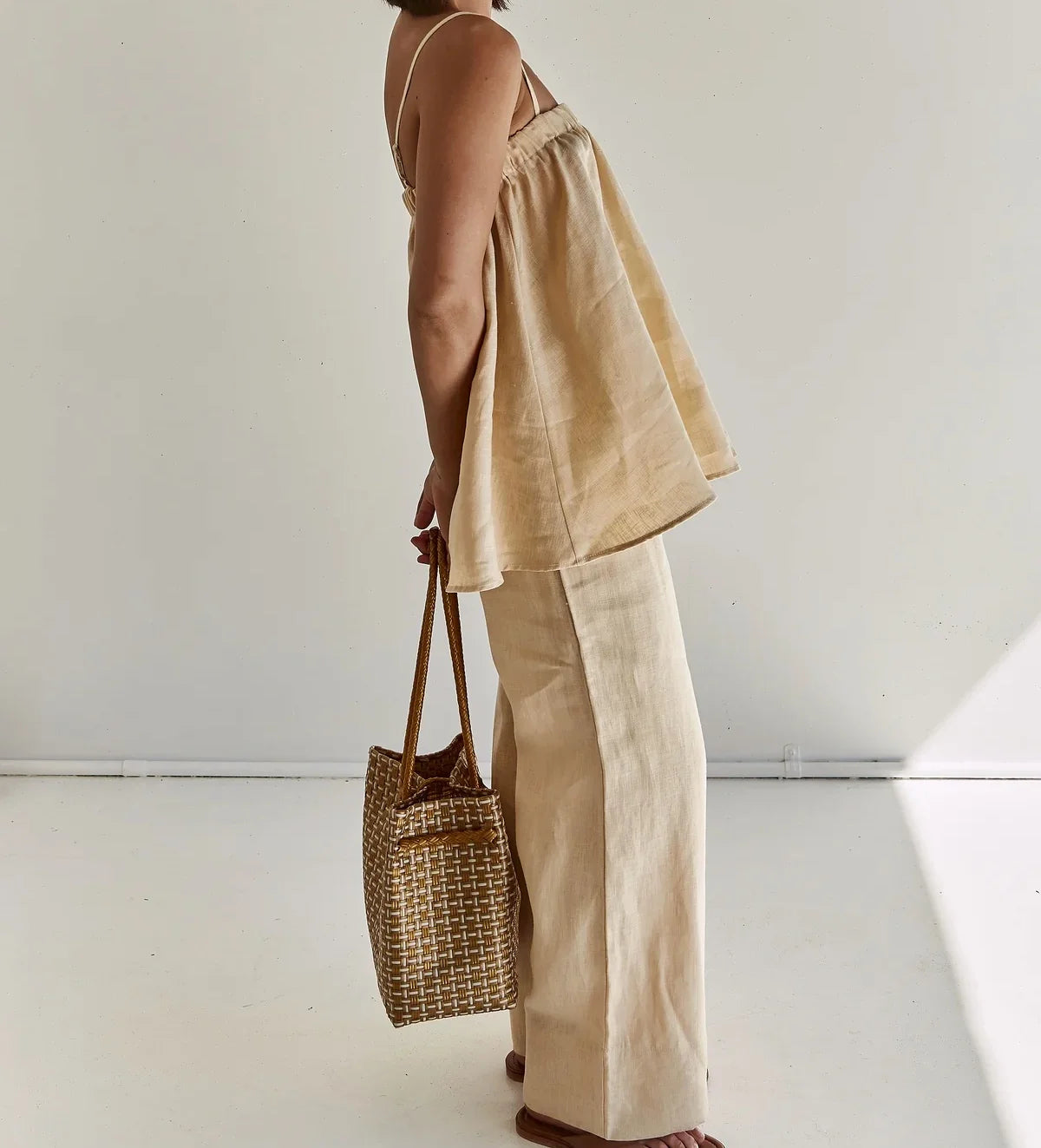 Side view of beige cotton cami and pants with tote bag