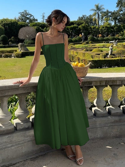 Green Corset Square Neck Midi Dress – lifestyle shot seated in a garden