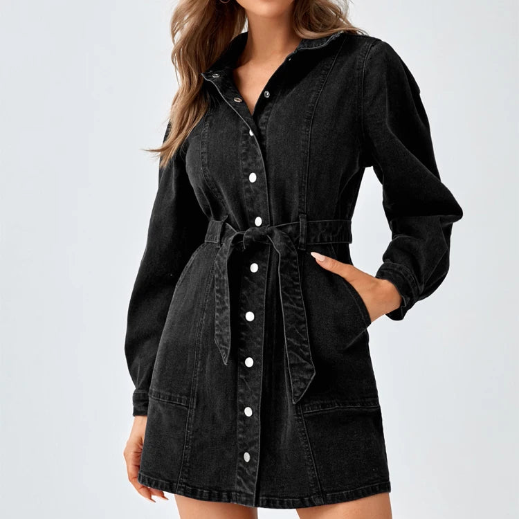 Front view of black denim belted shirt dress with snap-button front and hand in pocket