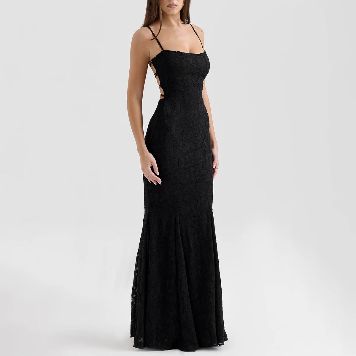 Side view of black lace maxi dress showing lace-up side detail