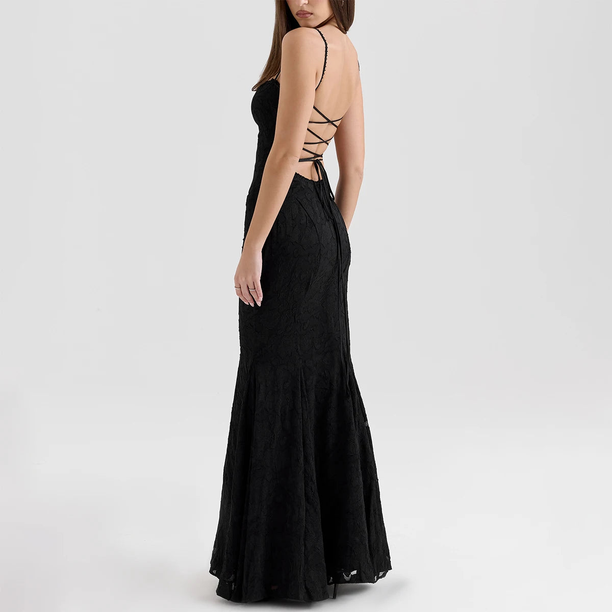 Three-quarter back view of black lace maxi dress with lace-up back