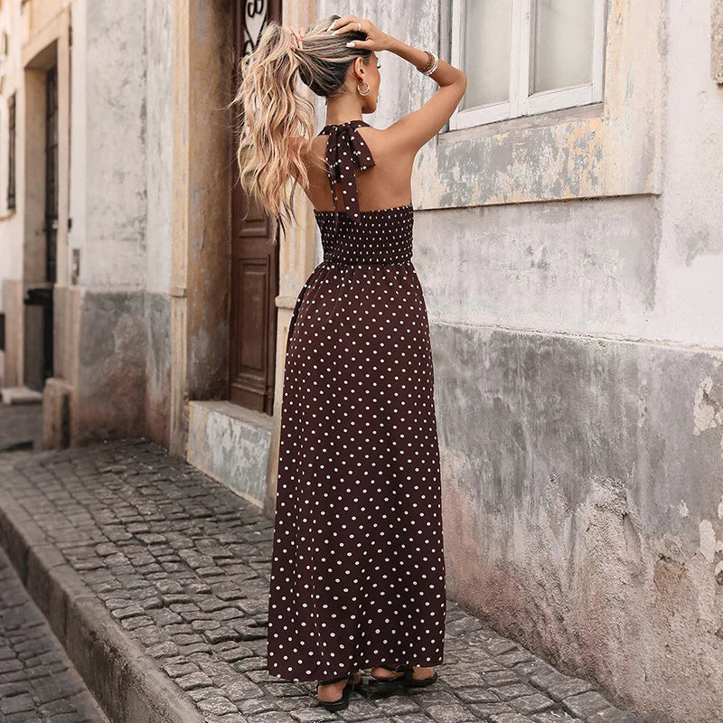 Back view of brown polka dot maxi dress with halter tie and smocked back