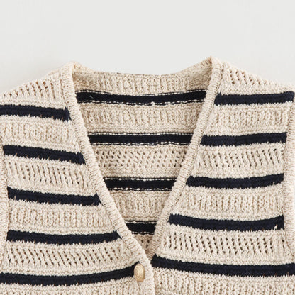 Close-up of V-neckline and open knit on striped vest