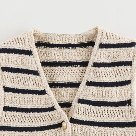 Close-up of V-neckline and open knit on striped vest