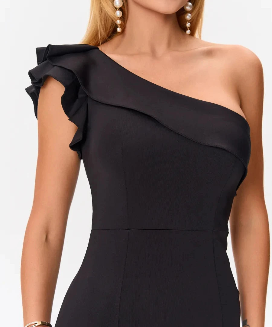 Close-up of layered ruffle on one-shoulder neckline of black dress