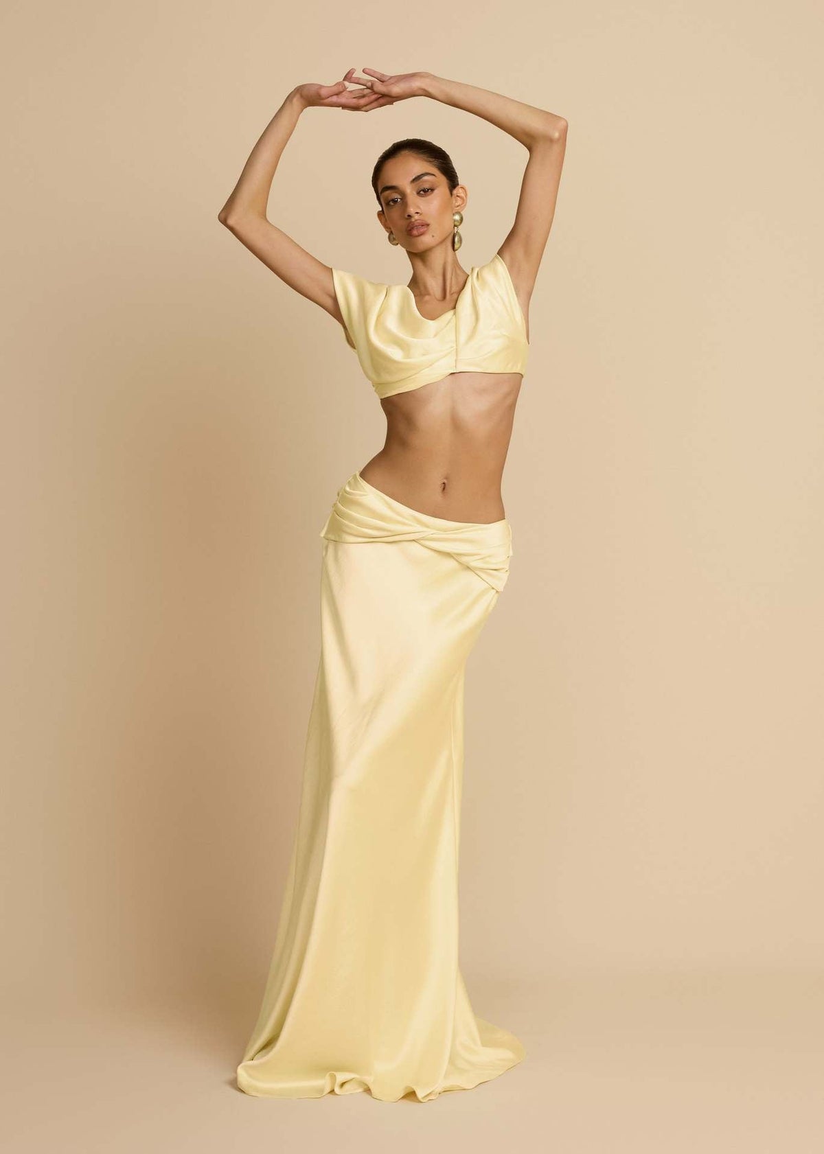 Yellow Twist Crop Top & Maxi Skirt Set – front view with arms raised