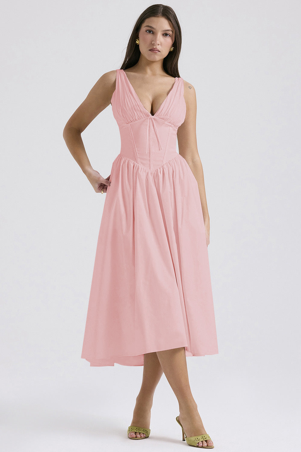 Ruched V-Neck Flared Midi Dress in Pink – front view with hand on hip