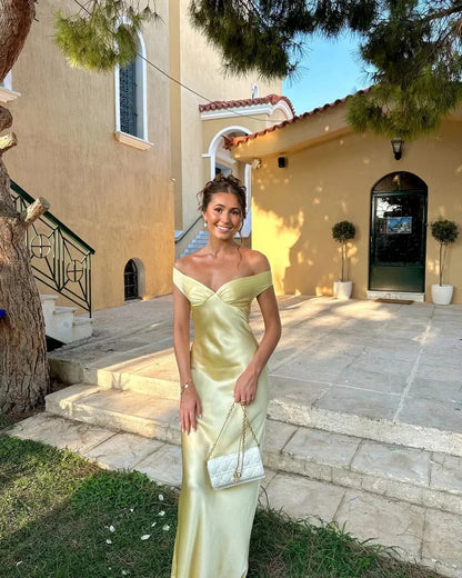 Yellow Off-Shoulder Draped Maxi Dress – front view on steps